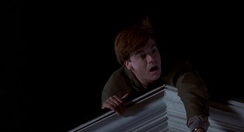 Movie still from “So I Married an Axe Murderer” (1993), directed by Thomas Schlamme – A young man is looking over a railing; Medium shot, Low angle