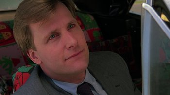 Movie still from “Something Wild” (1986), directed by Jonathan Demme – A person wearing a suit and tie; Close Up shot, Low angle