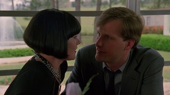 Movie still from “Something Wild” (1986), directed by Jonathan Demme – A man and a woman sitting next to each other in front of a window; Close Up shot, Over the shoulder angle