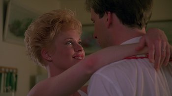 Movie still from “Something Wild” (1986), directed by Jonathan Demme – A man and a woman embracing each other in front of a mirror; Close Up shot, Low angle