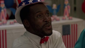 Movie still from “Something Wild” (1986), directed by Jonathan Demme – A man wearing a patriotic hat and a bow tie; Close Up shot, Low angle