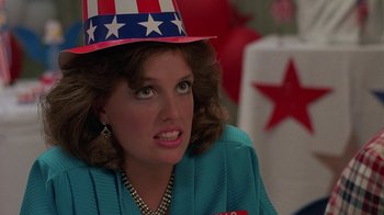 Movie still from “Something Wild” (1986), directed by Jonathan Demme – A person wearing a hat; Close Up shot, Over the shoulder angle