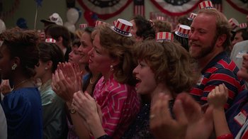 Movie still from “Something Wild” (1986), directed by Jonathan Demme – A group of people wearing patriotic hats clapping; Close Up shot, High angle