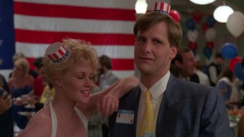Movie still from “Something Wild” (1986), directed by Jonathan Demme – A man and a woman wearing party hats; Medium shot, Low angle