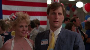 Movie still from “Something Wild” (1986), directed by Jonathan Demme – A man and a woman standing next to each other in front of an american flag; Close Up shot, Low angle