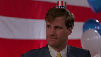 Movie still from “Something Wild” (1986), directed by Jonathan Demme – A man wearing a hat with the american flag on top of his head; Close Up shot, Low angle