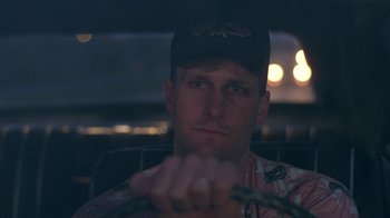 Movie still from “Something Wild” (1986), directed by Jonathan Demme – A person in a car at night; Close Up shot, Over the shoulder angle