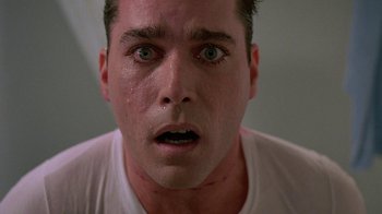 Movie still from “Something Wild” (1986), directed by Jonathan Demme – A man's face as he stares into the camera; Close Up shot, Low angle