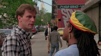Movie still from “Something Wild” (1986), directed by Jonathan Demme – A man and a woman talking on the sidewalk; Close Up shot, Over the shoulder angle