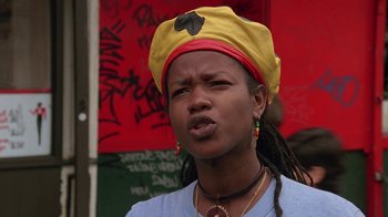 Movie still from “Something Wild” (1986), directed by Jonathan Demme – A woman wearing a yellow hat and a blue t - shirt; Close Up shot, Low angle