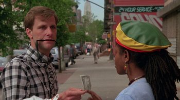 Movie still from “Something Wild” (1986), directed by Jonathan Demme – A man is talking to a woman on the street; Close Up shot, Over the shoulder angle