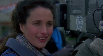 Movie still from “Groundhog Day” (1993), directed by Harold Ramis – A person smiling for a picture; Close Up shot, Over the shoulder angle