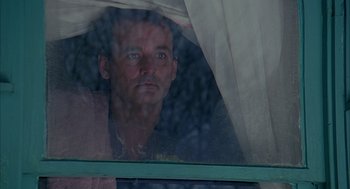Movie still from “Groundhog Day” (1993), directed by Harold Ramis – A man looking out of a window at the rain; Close Up shot, Low angle