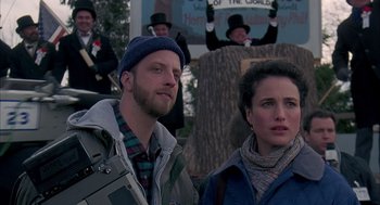 Movie still from “Groundhog Day” (1993), directed by Harold Ramis – A man and a woman standing next to each other; Medium shot, Over the shoulder angle