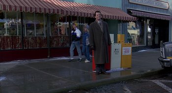Movie still from “Groundhog Day” (1993), directed by Harold Ramis – A man standing in the middle of the street; Wide shot, High angle