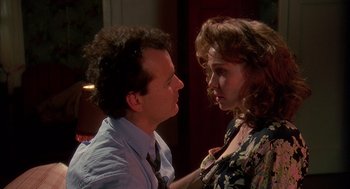 Movie still from “Groundhog Day” (1993), directed by Harold Ramis – A man and a woman face to face in a room; Close Up shot, Over the shoulder angle