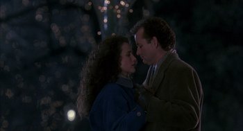 Movie still from “Groundhog Day” (1993), directed by Harold Ramis – A man and a woman standing next to each other in the dark; Medium shot, Low angle