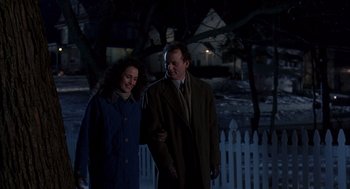 Movie still from “Groundhog Day” (1993), directed by Harold Ramis – A man and a woman are walking in the dark; Medium shot, Over the shoulder angle
