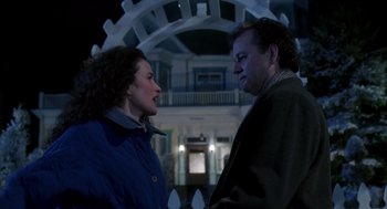 Movie still from “Groundhog Day” (1993), directed by Harold Ramis – A man and a woman standing next to each other; Medium shot, Low angle