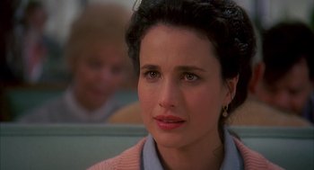 Movie still from “Groundhog Day” (1993), directed by Harold Ramis – A person sitting in a chair; Close Up shot, Over the shoulder angle