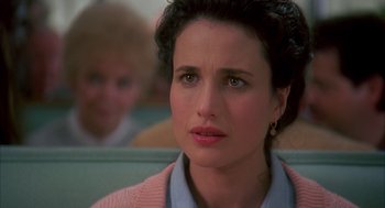 Movie still from “Groundhog Day” (1993), directed by Harold Ramis – A person sitting in a chair; Close Up shot, Over the shoulder angle