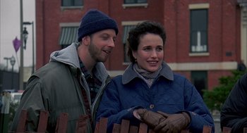 Movie still from “Groundhog Day” (1993), directed by Harold Ramis – A man and a woman standing next to each other near a fence; Medium shot, Over the shoulder angle
