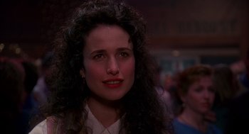 Movie still from “Groundhog Day” (1993), directed by Harold Ramis – A person with curly black hair; Close Up shot, Over the shoulder angle