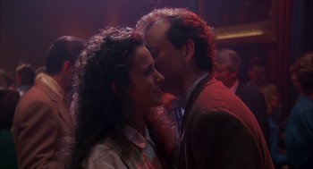 Movie still from “Groundhog Day” (1993), directed by Harold Ramis – A man and a woman are kissing in a room; Close Up shot, Over the shoulder angle