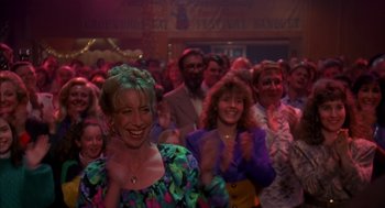 Movie still from “Groundhog Day” (1993), directed by Harold Ramis – A group of people are clapping in a crowd; Medium shot, Over the shoulder angle