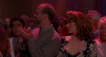 Movie still from “Groundhog Day” (1993), directed by Harold Ramis – A man and a woman standing next to each other in a room; Medium shot, Over the shoulder angle