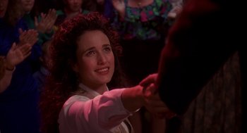 Movie still from “Groundhog Day” (1993), directed by Harold Ramis – A woman is shaking someone's hand at a party; Close Up shot, Over the shoulder angle