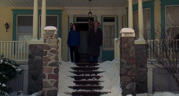 Movie still from “Groundhog Day” (1993), directed by Harold Ramis – A man and a woman walking down the steps of a house; Wide shot, Low angle
