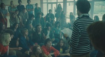 Movie still from “Something in the Air” (2012), directed by Olivier Assayas – A group of young people sitting in a room; Wide shot, High angle