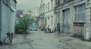 Movie still from “Something in the Air” (2012), directed by Olivier Assayas – An old car is parked in the middle of an empty street; Extreme Wide shot, High angle