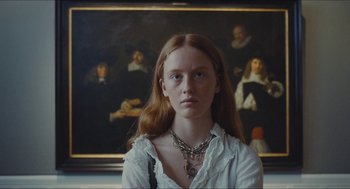 Movie still from “Something in the Air” (2012), directed by Olivier Assayas – A woman with long red hair wearing a white shirt; Close Up shot, Low angle