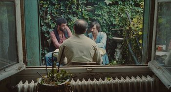 Movie still from “Something in the Air” (2012), directed by Olivier Assayas – Two men are sitting in front of a mirror; Wide shot, Over the shoulder angle