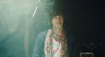 Movie still from “Something in the Air” (2012), directed by Olivier Assayas – A man with a cigarette in his mouth; Medium shot, Low angle