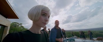 Movie still from “Song to Song” (2017), directed by Terrence Malick – A woman and a man standing next to each other near a pool; Close Up shot, Over the shoulder angle