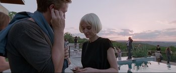 Movie still from “Song to Song” (2017), directed by Terrence Malick – A man and a woman standing next to each other looking at a cell phone; Medium shot, Low angle