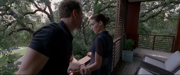 Movie still from “Song to Song” (2017), directed by Terrence Malick – A man and a woman standing next to each other on a porch; Medium shot, Over the shoulder angle