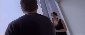 A man and a woman in front of a bathroom mirror