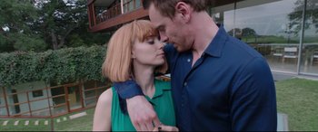 Movie still from “Song to Song” (2017), directed by Terrence Malick – A man and a woman kissing in front of a building; Close Up shot, Low angle