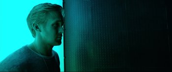 Movie still from “Song to Song” (2017), directed by Terrence Malick – A man standing in front of a green wall; Close Up shot, Low angle