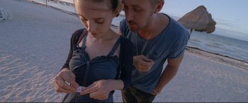 Movie still from “Song to Song” (2017), directed by Terrence Malick – A man and a woman looking at a cell phone; Close Up shot, High angle