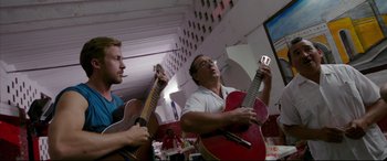 Movie still from “Song to Song” (2017), directed by Terrence Malick – Two men are playing guitar in a restaurant; Medium shot, Low angle
