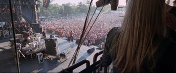 A crowd of people at an outdoor concert