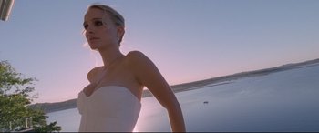 Movie still from “Song to Song” (2017), directed by Terrence Malick – A woman in a strapless white dress standing in front of a body of water; Close Up shot, Low angle