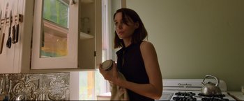 Movie still from “Song to Song” (2017), directed by Terrence Malick – A woman holding a cup in her hand; Medium shot, Low angle