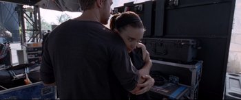 Movie still from “Song to Song” (2017), directed by Terrence Malick – A man and a woman hugging in front of an array of equipment; Medium shot, Over the shoulder angle