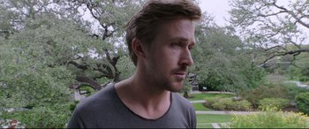 Movie still from “Song to Song” (2017), directed by Terrence Malick – A person wearing a gray shirt; Close Up shot, Over the shoulder angle